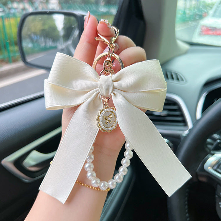 Bow Pearl Metal Wristlet