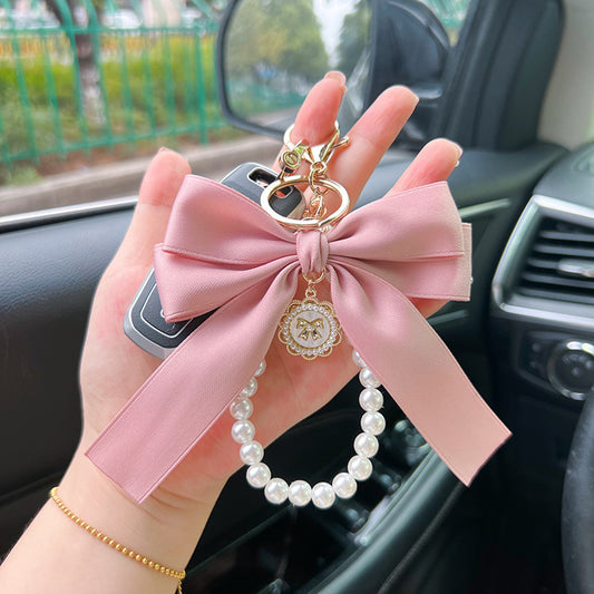 Bow Pearl Metal Wristlet