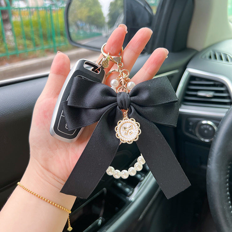 Bow Pearl Metal Wristlet